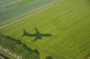 Meninger shadow of a plane on a green field